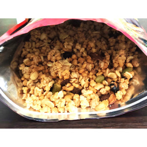 Hand holding spoonful of Calbee whey protein granola mixture