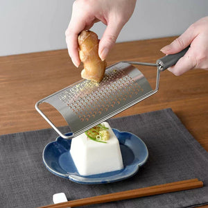 Close-up of Arnest Handheld 2-Way Fine And Coarse Cheese Grater, featuring dual blades for precise results