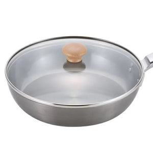 Close-up of Chitose iron frying pan 24cm featuring solid construction and clear glass lid