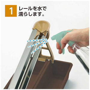 Close-up of Akebono Egg Slide Separator, stainless steel rail, featuring heat-resistant material for durability