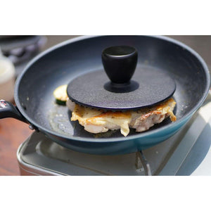Ikenaga Cast Iron Grill Press in use on sandwich with grill marks forming