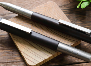Close-up of Meiji Titanium Ballpoint Pen, titanium grip and ebony wood detail for comfortable use