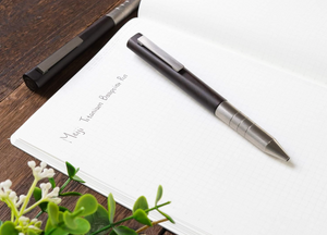 Close-up of Meiji Titanium Ballpoint Pen, titanium grip and ebony wood detail for comfortable use