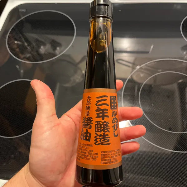 Close-up of Kamebishi Soy Sauce, 200ml, featuring rich umami for grilling