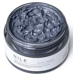 “Close-up texture of NILE Mud Pack showing creamy mud with mineral clay particles”