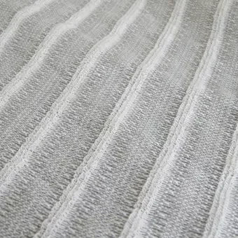 Orim Binchotan Charcoal Body Scrub Towel in use, showcasing gentle exfoliating fibers for smooth skin