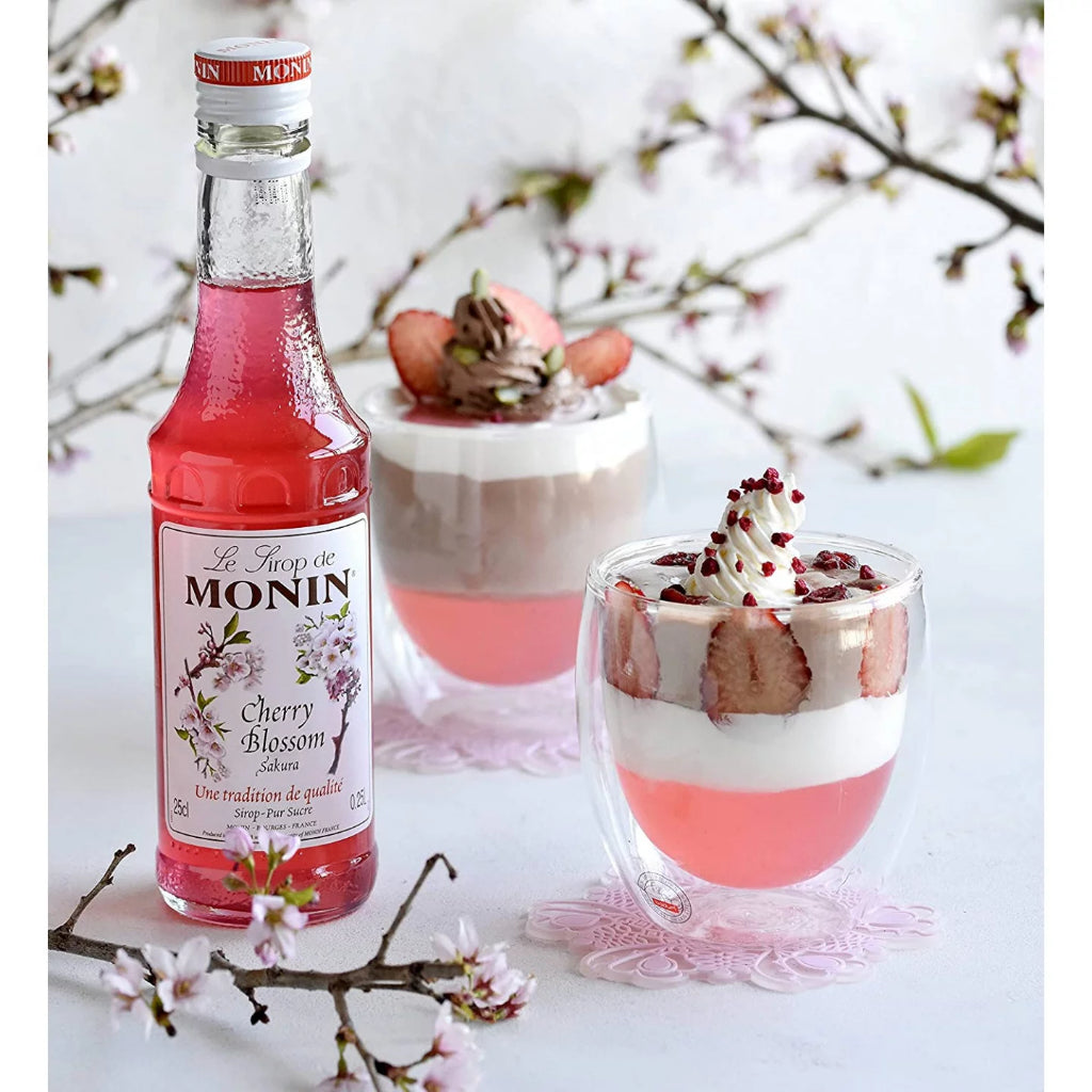 Close-up of Monin Sakura Syrup, 700ml, featuring light pink hue for elegant drinks