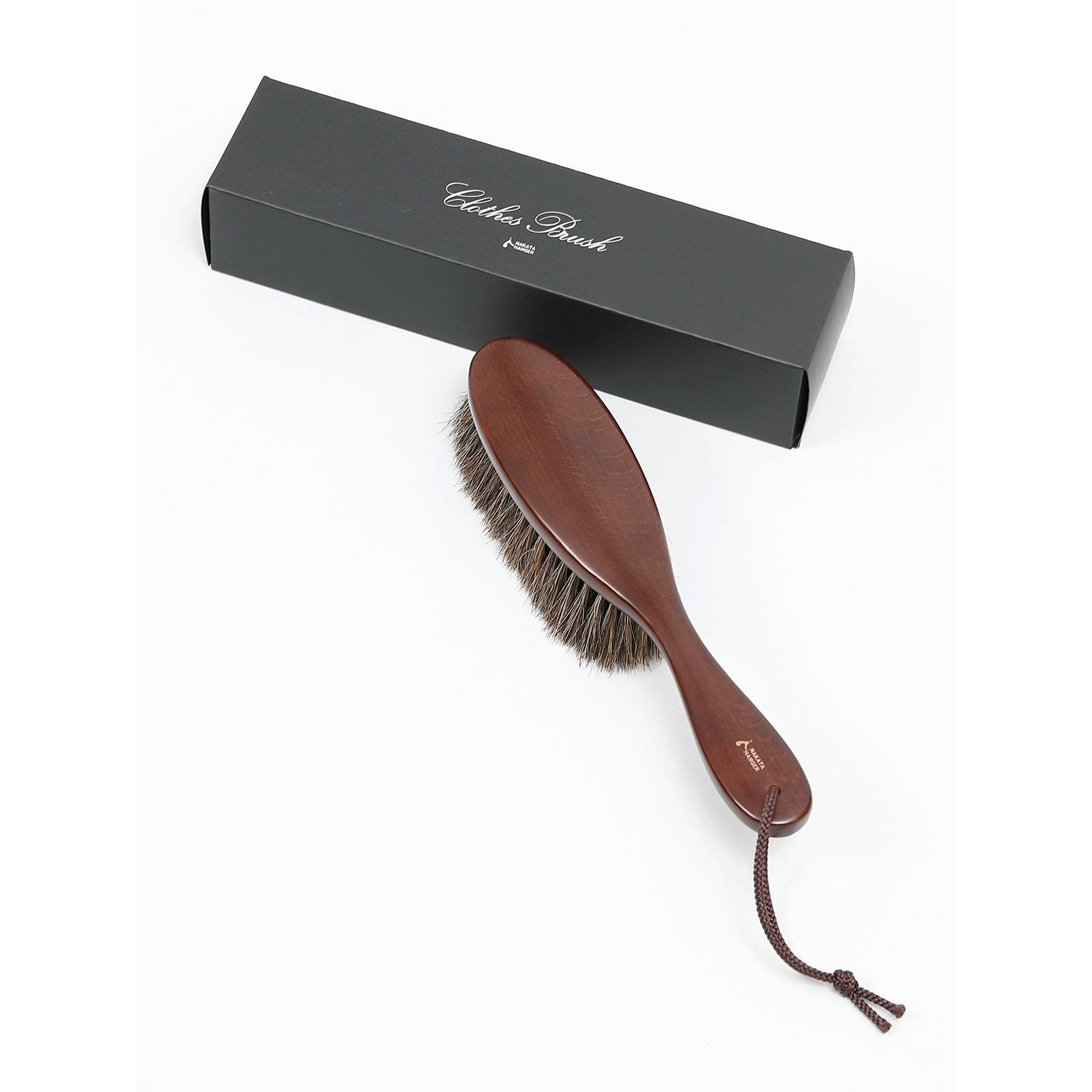 Close-up of Nakata Hanger Clothes Brush with natural bristles, showing soft texture for delicate fabric care