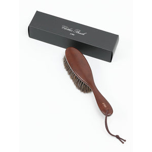 Close-up of Nakata Hanger Clothes Brush with natural bristles, showing soft texture for delicate fabric care