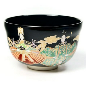 Close-up of Ningyo doll artwork on black chawan matcha bowl