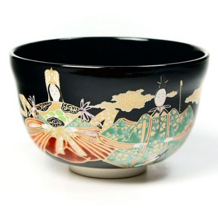Close-up of Ningyo doll artwork on black chawan matcha bowl