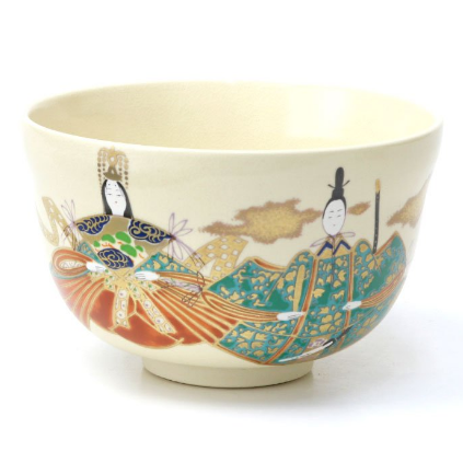 The chawan cup resting on wooden table, highlighting white glaze and design