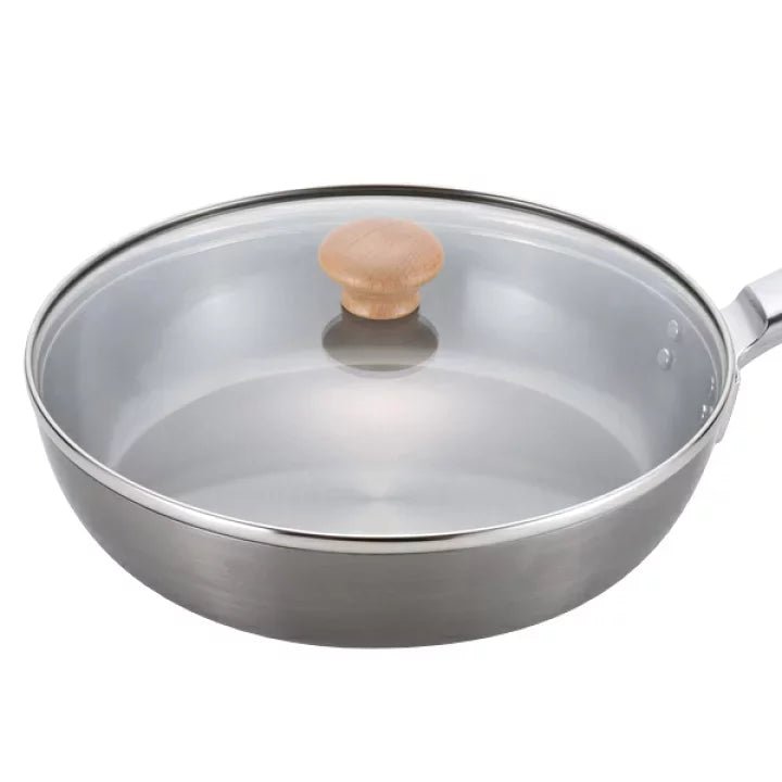 Close-up of Chitose iron frying pan 24cm featuring solid construction and clear glass lid