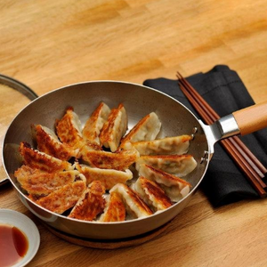 24cm Chitose iron frying pan with glass lid, offering steady heat for daily kitchen use