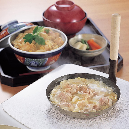 Pan placed over induction cooktop, demonstrating IH compatibility