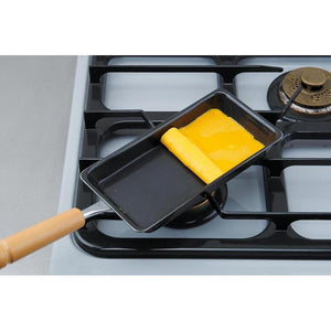 Close-up of Summit Rectangular Cast Iron Tamagoyaki Pan, featuring wooden handle for easy grip