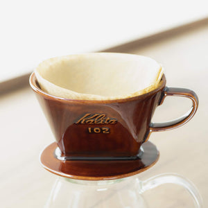 Close-up of Kalita Ceramic Coffee Dripper 102 Brown, showing flat-bottom with three-hole drainage for balanced extraction
