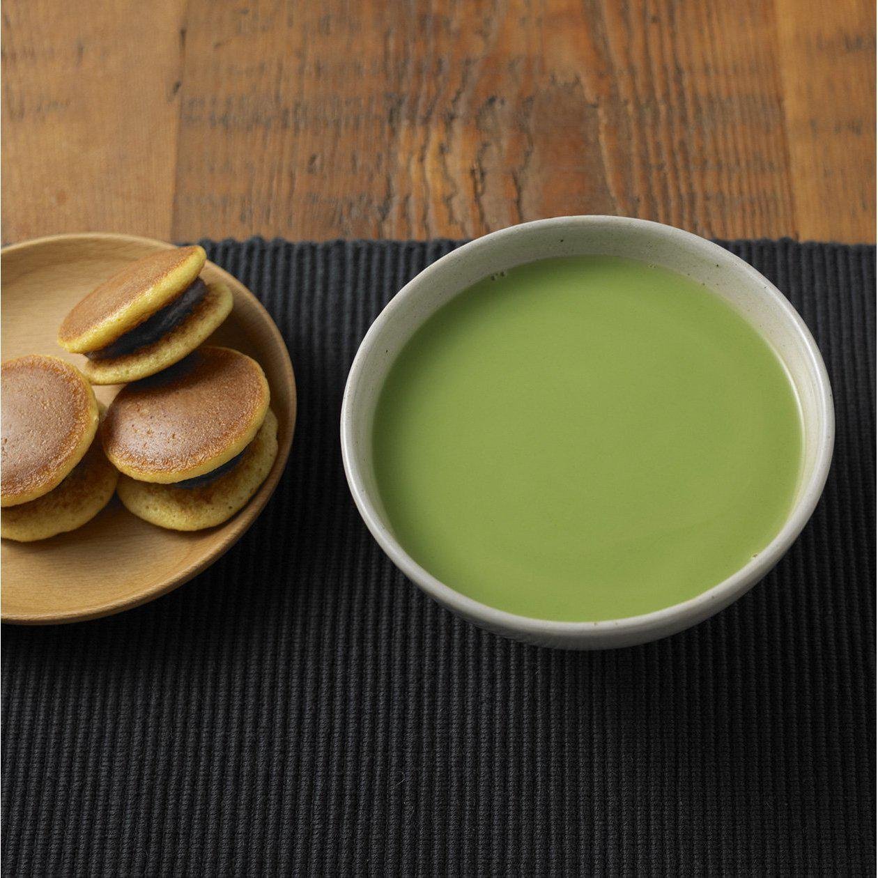 Close-up of Muji Instant Matcha Latte Green Tea with Milk Powder, 170g, featuring smooth texture for rich flavor