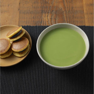Close-up of Muji Instant Matcha Latte Green Tea with Milk Powder, 170g, featuring smooth texture for rich flavor
