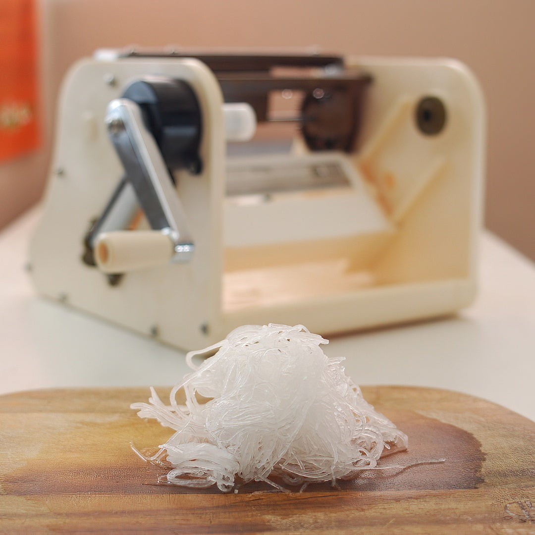 Close-up of Chiba Plastic Katsuramuki Peeler S Turning Slicer, S size, featuring ergonomic handle for precise control