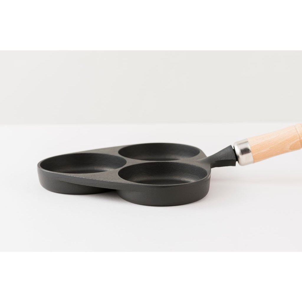 Close-up of Iwachu Wooden Handle Egg Frying Pan Induction Cast Iron 3 Egg Pan, featuring wooden handle for safe grip and even heat