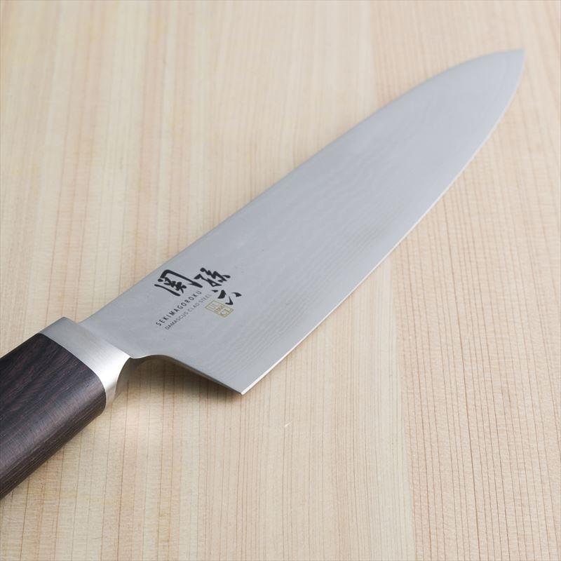 Close-up of Kai Seki Magoroku Damascus Gyuto Chef's Knife, 210mm, featuring 32-layer Damascus steel for durability