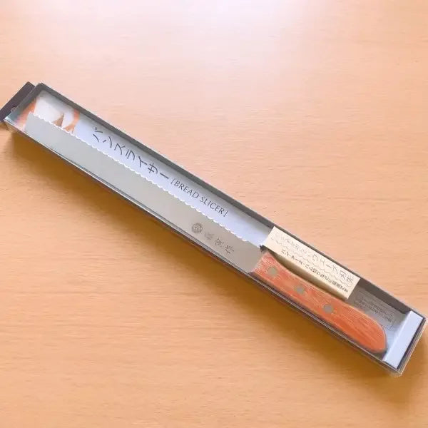 Close-up of Tojiro FU-737 bread slicer showing serrated stainless steel edge