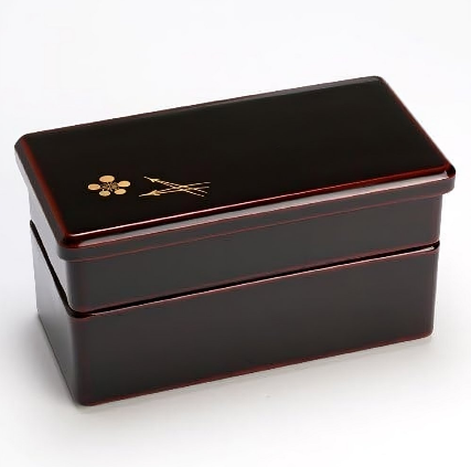 Isuke red two-tier bento box with plum motif, offering organized meal storage for bento lovers