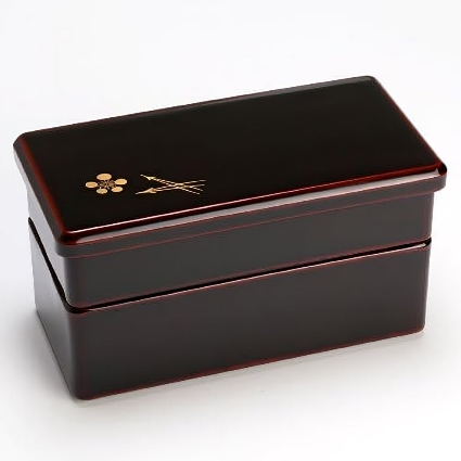 Two-tier Isuke Red Bento Box with plum blossoms, offering practical and elegant lunch storage